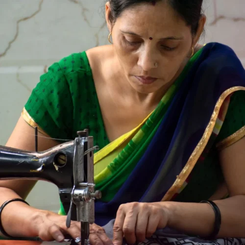Artisan stitching fabric on a sewing machine