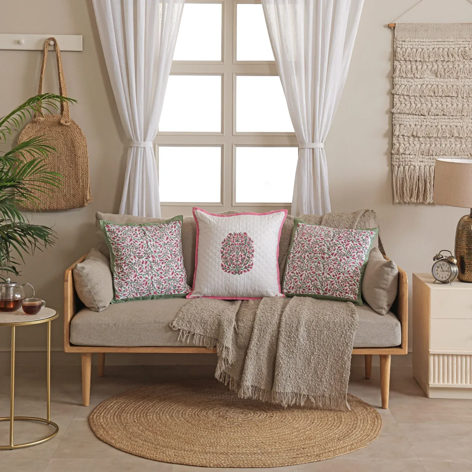 Gulabi Haze hand block printed cushion covers on a sofa