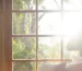 Sunlight through a wooden window onto cushions
